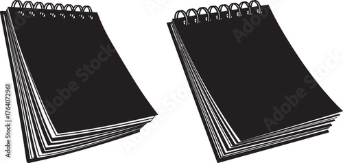Two black spiral bound notebooks silhouette