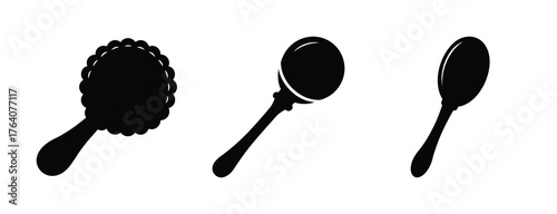 Three black silhouettes of baby rattles and a spoon displayed together on a