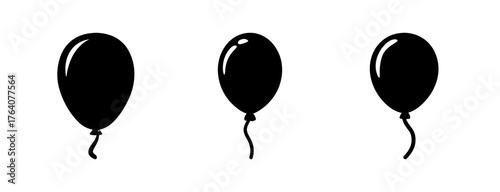 Three black balloons with strings floating upwards for celebrations and parties fun