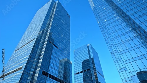 Wallpaper Mural Low-angle view of several modern skyscrapers with reflective glass against a bright blue sky Torontodigital.ca