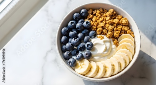 Healthy breakfast bowl with granola and fresh fruit, top view