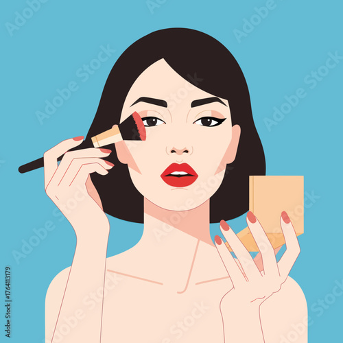 Beautiful young woman applying blush with a makeup brush.