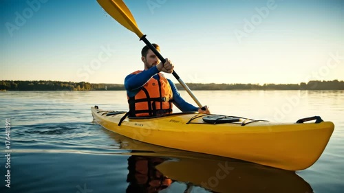 Man Enjoys Kayaking at Sunrise on Calm Lake Water Adventure