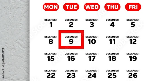 The date December 9th marked with a red cursor on the wall calendar 2025