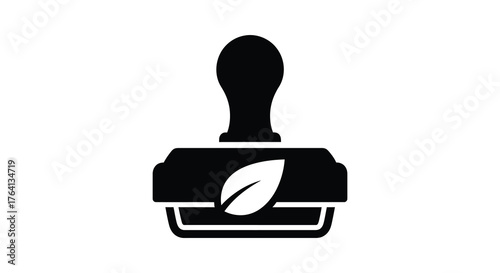Black silhouette of a rubber stamp with a leaf symbol for eco friendly certification and organic product approval silhouette