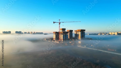 City Skyline with Construction Cranes and Misty Environment at Dawn