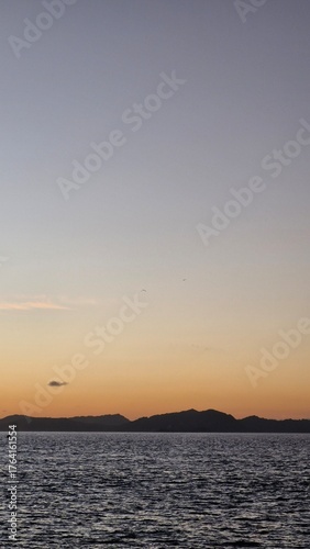 Serene sunset over the ocean creates a peaceful and calming atmosphere, perfect for travel inspiration or promoting relaxation and mindfulness retreats