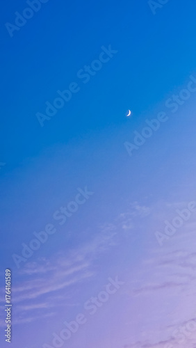 Capture the serene beauty of a crescent moon in a tranquil gradient sky, perfect for adding a calming touch to your next project or design aesthetic.