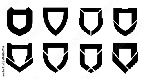 Collection of minimalist black shield silhouettes. Strong, modern geometric shapes perfect for security company logos, gaming clan emblems, or protection icons.