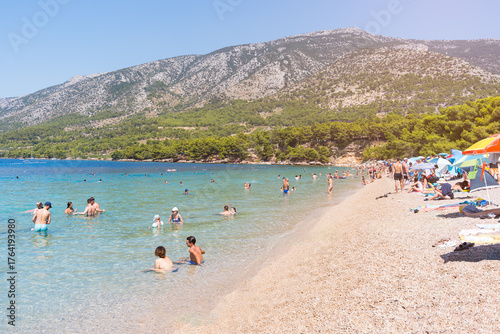 Fototapeta Naklejka Na Ścianę i Meble -  Brac Island beach people swimming vacationing in Adriatic Sea