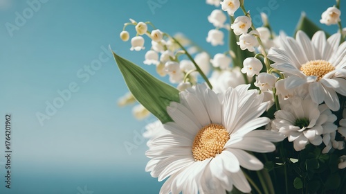 Delicate Floral Arrangement Featuring White Daisies and Lily of the Valley Against a Soft Blue Backdrop