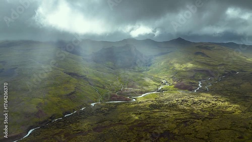 Dramatic moody landscape with flowing rivers, mountains, and vibrant green moss creating a cinematic travel experience, perfect for adventure