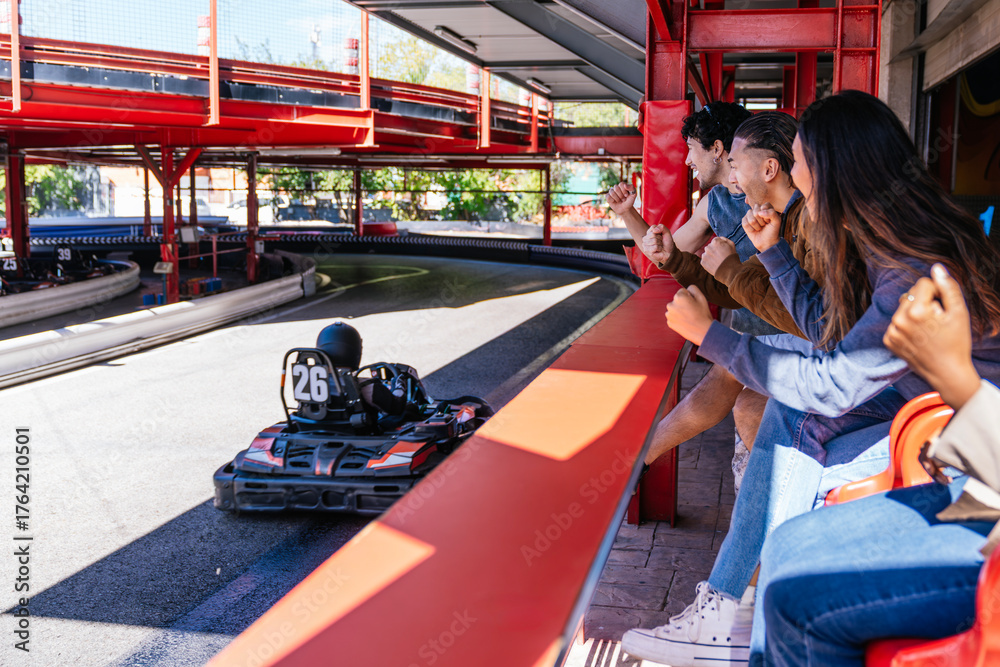 Fototapeta premium Friends cheering, experiencing excitement and competition at a go kart track, enjoying a fun day together