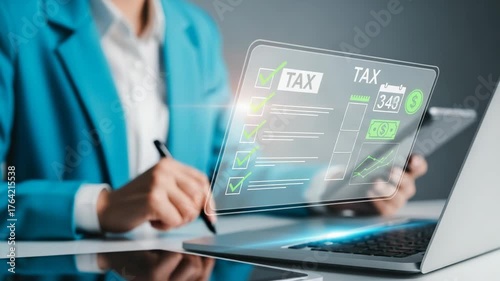 Person completing tax form on laptop with digital overlay of financial data and checklist items