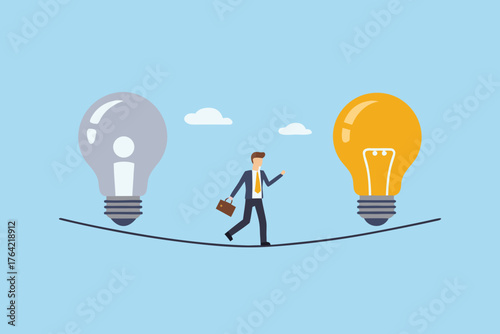 Businessman walking a tightrope between a lit and unlit light bulb representing ideas and challenges