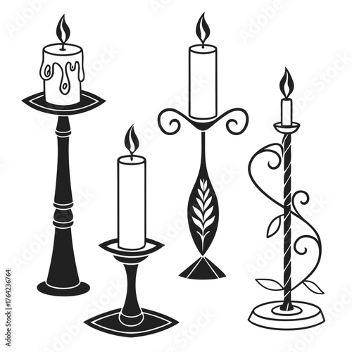 Set of black candle holders with burning candles