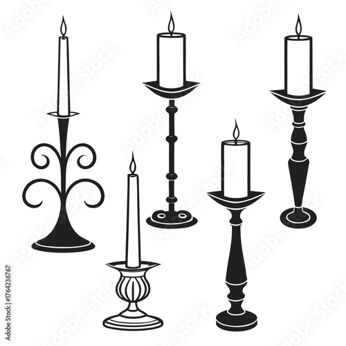 Collection of black candle holders with burning candles