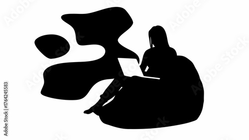 Silhouette of a woman sitting on a beanbag chair using a laptop with abstract shapes in the background