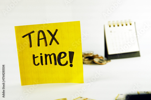 Tax Season: tax time reminder background digitally generated image stock photo copy space yellow note pad vertically with coins stacks and calendar background concepts related to tax season