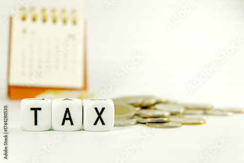 Tax Season: tax time reminder background digitally generated image stock photo copy space white dice spelling TAX horizontally coins stacks money bank and coins and calendar background concepts