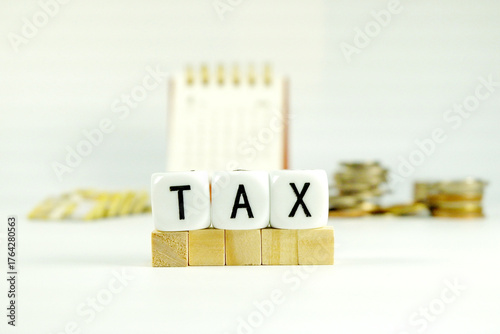 Tax Season: tax time reminder background digitally generated image stock photo copy space white dice spelling TAX horizontally coins stacks money bank and coins and calendar background concepts 