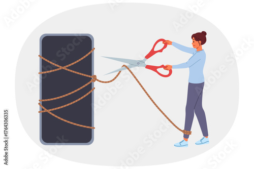 Digital detox is done by woman with mobile phone, cutting rope with scissors to get rid of addiction. Importance of digital detox in modern life to combat attachment to gadgets and social networks