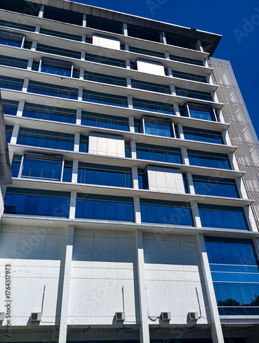 High building, windows on building, building under blue skies