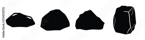 Collection of four diverse black rocks showing varied textures and shapes isolated on white