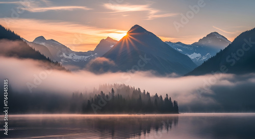 Misty mountain sunrise over a serene lake