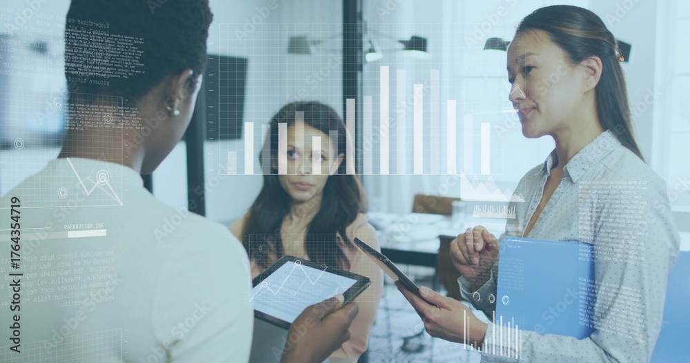 Obraz premium Collaborating businesswomen analyzing data in office meeting room, with tablets and hologram charts