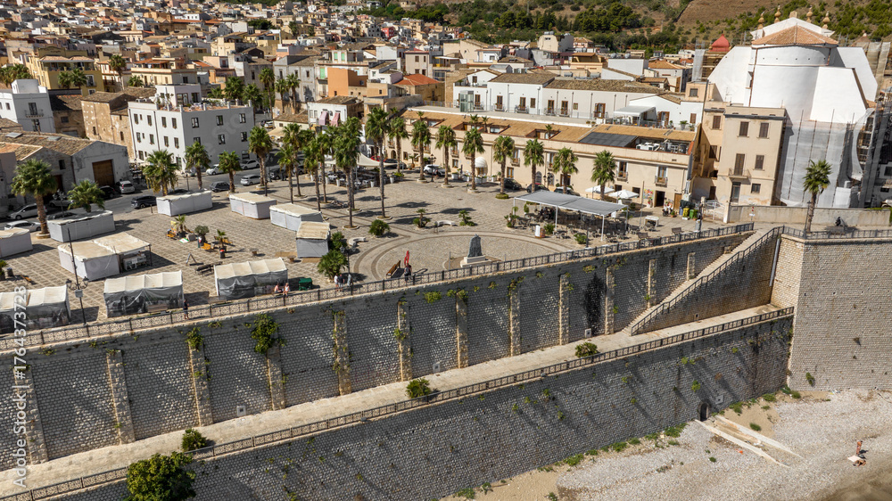 Fototapeta premium Aerial view of the main square of Castellammare del Golfo, a town located in province of Trapani, Sicily, Italy. The town center has many shops, cafes and restaurants.