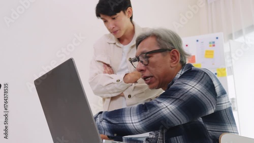 Group of asian senior in a collaborative software development analyzing  flowcharts  during a bootcamp training