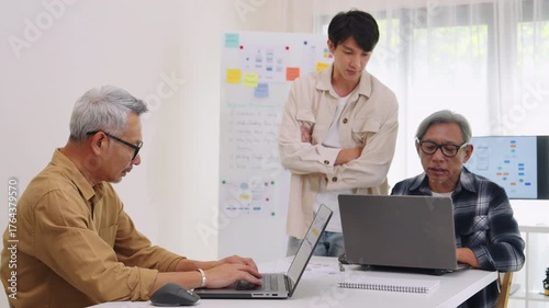 Asian Instructor Teaching Senior in Software Programming and Training Collaboration