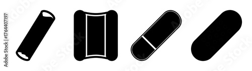 Collection of simple black bandages and medical capsules symbolizing health and care in healthcare