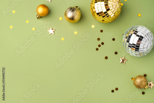 Festive Christmas gold ornaments on a green background.