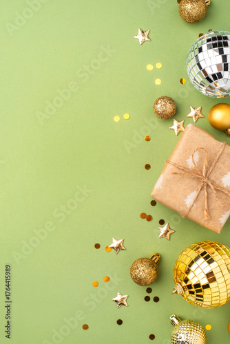 Christmas gift with gold ornaments on a green background.