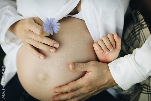 pregnant woman touching her belly