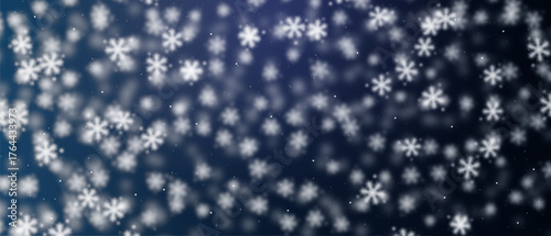 Blurred snowfall on dark blue background, volumetric effect, bokeh effect