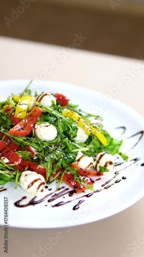 pouring balsamic sauce on caprese canapes with cherry tomatoes and mozzarella cheese balls. High quality 4k footage