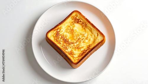 Fototapeta Naklejka Na Ścianę i Meble -  Delicious golden-brown French toast slice on a pristine white plate, a sweet breakfast treat perfect for celebrating French Toast Day, offering a simple morning indulgence