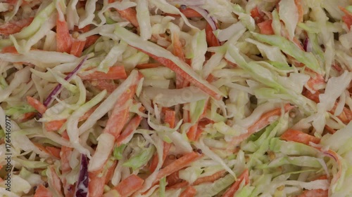 Coleslaw salad with cabbage, carrots food texture on light surface zoom top