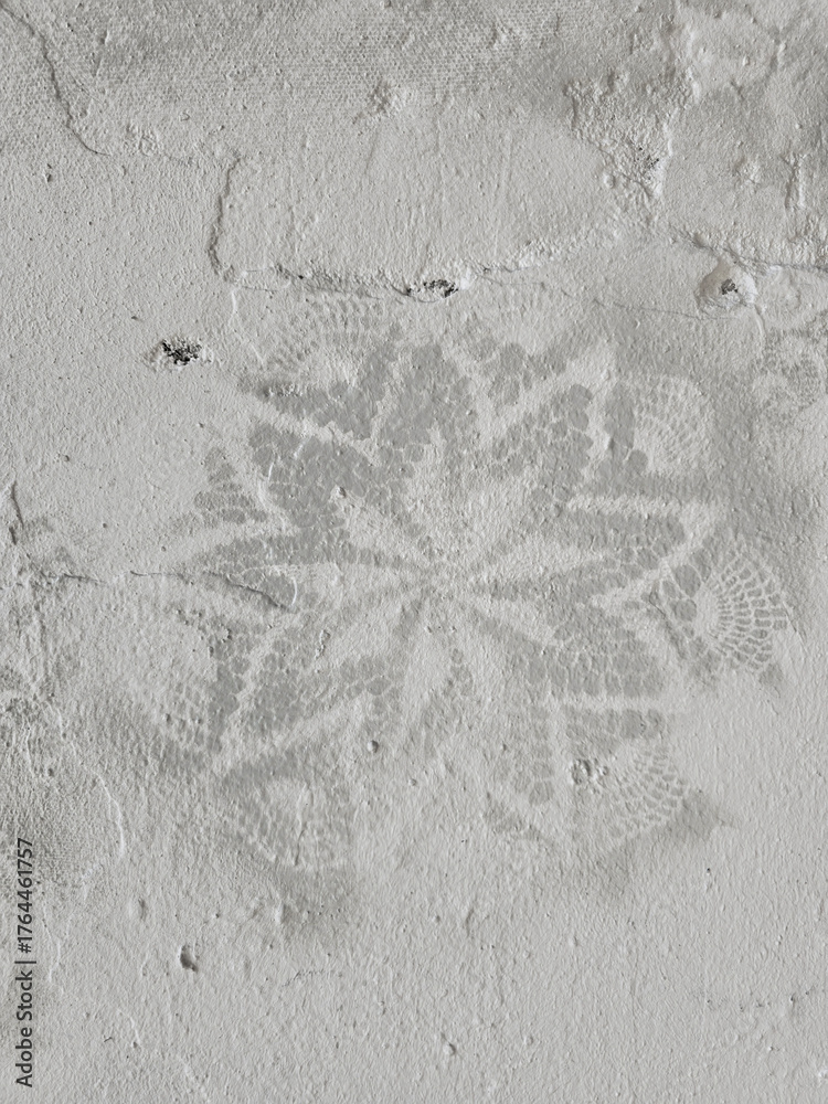 Fotografie The light gray wall texture has a barely noticeable imprint of a lacy floral pattern