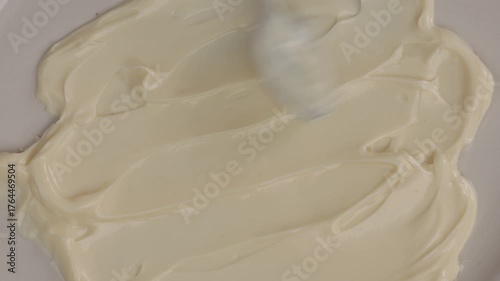 mayonnaise texture with a spoon smear food on light surface zoom top 