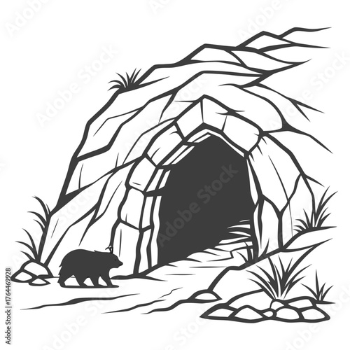 Silhouette of a bear walking towards a dark cave entrance in a rocky cliffside with sparse vegetation