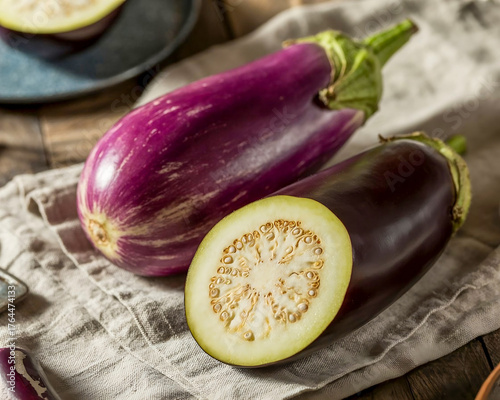 Fresh Purple Eggplant with Sliced Brinjal on Rustic Fabric