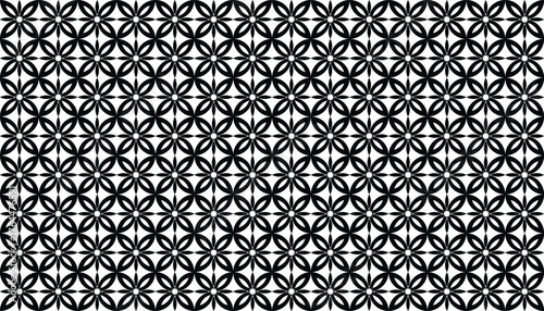 A seamless geometric floral pattern in black and white, composed of repeated petal-like shapes forming symmetrical flower motifs. The minimalist monochrome design gives a modern and elegant