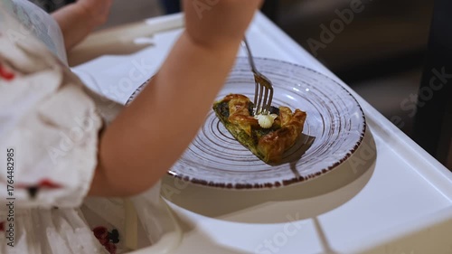 Child enjoys homemade pastry in cozy dining setting