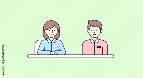 Two individuals sitting at a table, possibly in a work or office setting.
