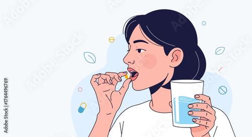 Young woman taking a pill with a glass of water.