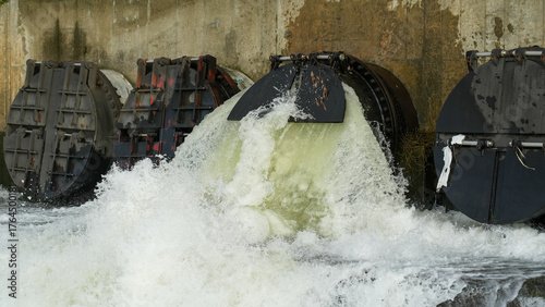 Close-up view of powerful water flow from industrial floodgate